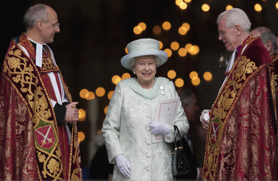 Britain's Queen Elizabeth II departs St Paul's Cathedral, London with the Dean of St Paul's David Ison, left, following a service of thanksgiving on the last day of the Queen's Diamond Jubilee celebrations in London, Tuesday, June 5, 2012. Crowds cheering "God save the queen!" and pealing church bells greeted Queen Elizabeth II on Tuesday as she arrived for a service at St. Paul's Cathedral on the last of four days of celebrations of her 60 years on the throne.(AP Photo/Alastair Grant)