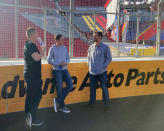 Dale Earnhardt Jr., right, talks with Ryan Preece, left, and Christopher Bell, center, who will race in the Busch Light Clash on a temporary auto racing track inside LA Coliseum ahead of a NASCAR exhibition race in Los Angeles, Friday, Feb. 4, 2022. NASCAR is hitting Los Angeles a week ahead of the Super Bowl, grabbing the spotlight with its wildest idea yet: The Clash, the unofficial season-opening, stock-car version of the Pro Bowl, will run at the iconic coliseum in a made-for-Fox Sports spectacular. (AP Photo/Jenna Fryer)