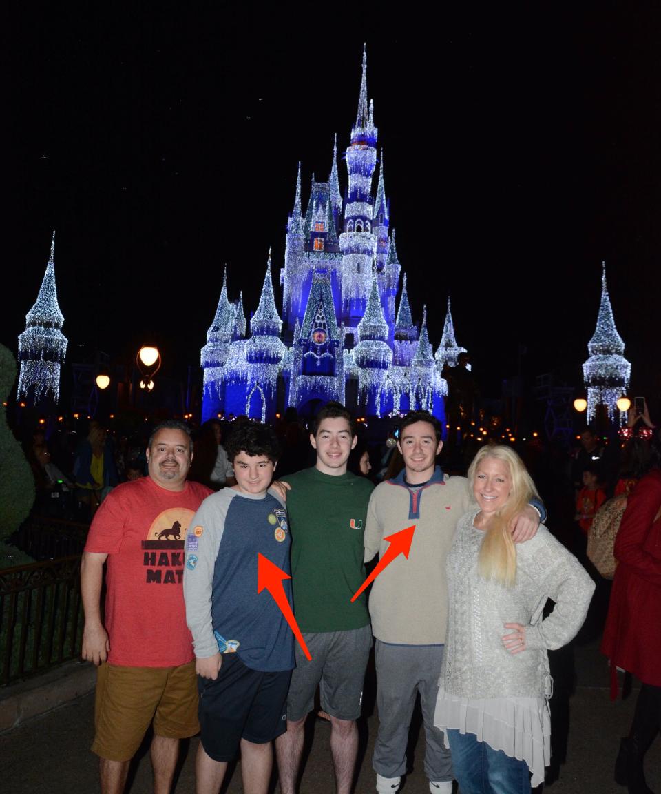 Greg Antonelle and his family at Magic Kingdom Park where two of his kids wear sweaters.