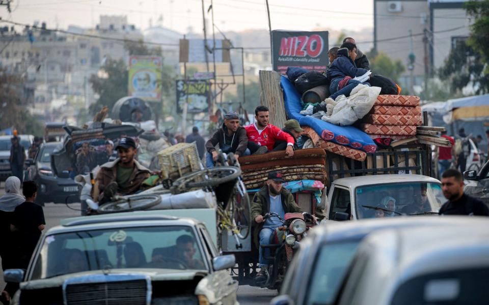 Displaced Palestinians flee Rafah with their belongings to safer areas in the southern Gaza Strip on May 7, 2024 following an evacuation order by the Israeli army the previous day