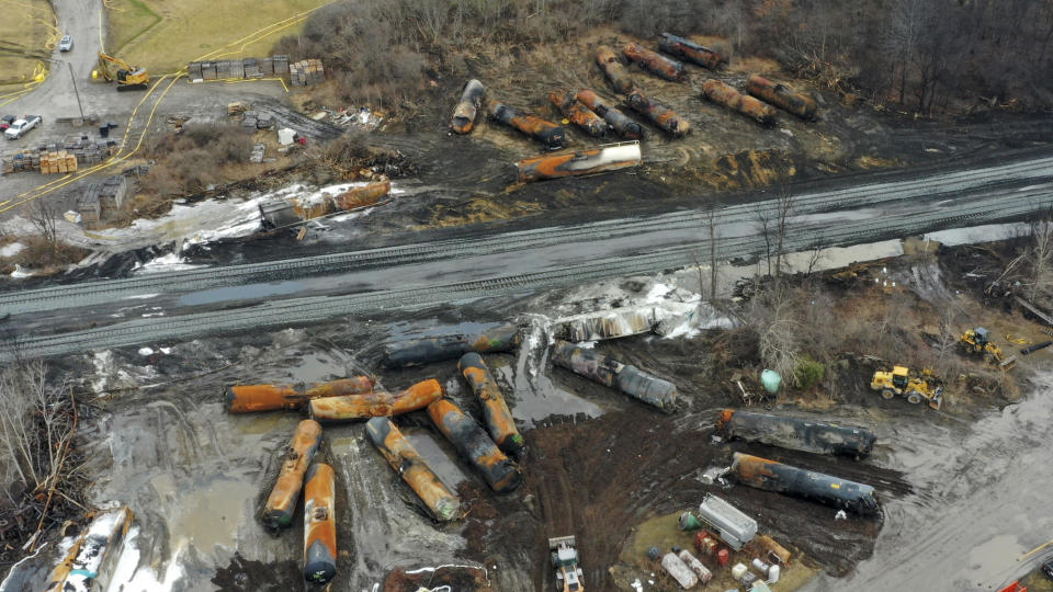 FILE - Cleanup of portions of a Norfolk Southern freight train that derailed Friday night in East Palestine, Ohio, continues on Feb. 9, 2023. Residents of eastern Ohio can now get an up-close view in newly released videos of the twin toxic towers of fire that forced them from their homes last February when officials decided to blow open five tank cars filled with vinyl chloride they worried might explode days after a Norfolk Southern train derailed. (AP Photo/Gene J. Puskar, File)