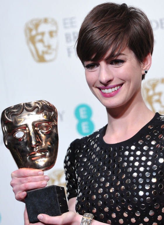 US actress Anne Hathaway poses with the award for best supporting actress for her performance in the film Les Miserables during the annual BAFTA British Academy Film Awards at the Royal Opera House in London on February 10, 2013