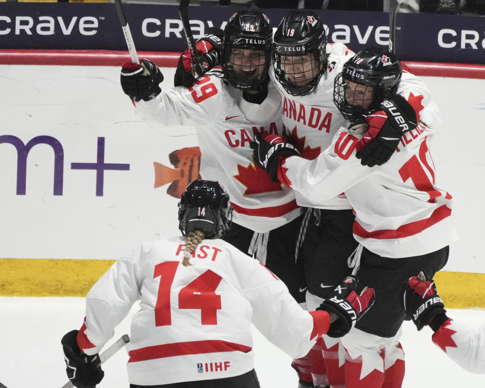 Canada's Marie-Philip Poulin celebrates her goal on the United States with teammates during the third period of a gold medal game at the women's world hockey championships in Utica, N.Y., Sunday, April 14, 2024. (Christinne Muschi/The Canadian Press via AP)