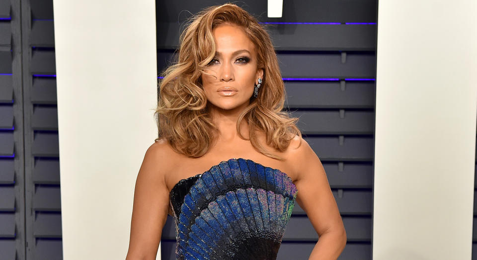 Just over one year after Jennifer Lopez attended the Vanity Fair Oscar she has released a new track and music video Pa Ti + Lonely, and her make-up artist has revealed the secret behind her glow. (Getty Images)