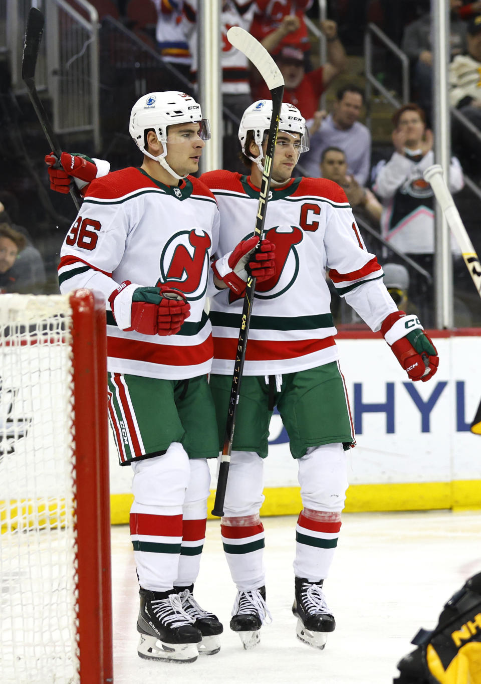 New Jersey Devils right wing Timo Meier (96) celebrates with center Nico Hischier (13) after scoring a goal against the Pittsburgh Penguins during the second period of an NHL hockey game Tuesday, April 4, 2023, in Newark, N.J. (AP Photo/Noah K. Murray)