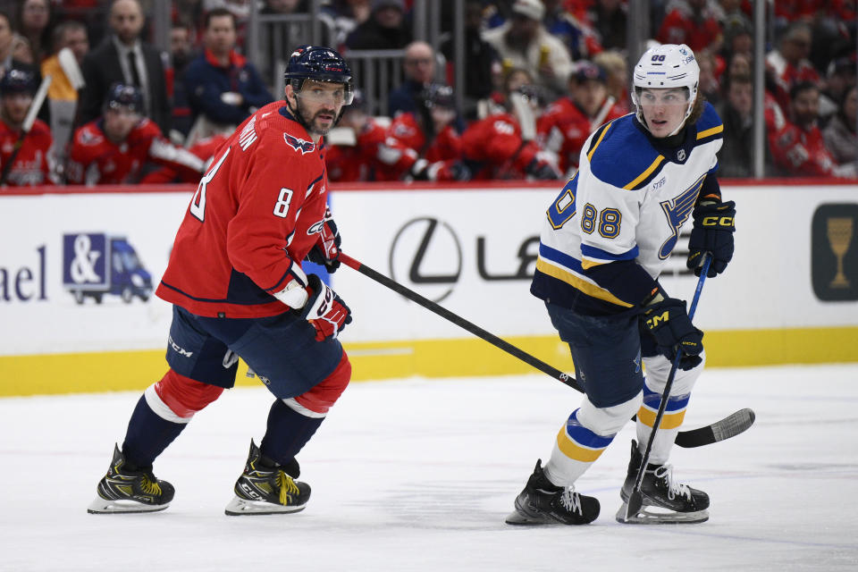 St. Louis Blues center Adam Gaudette (88) skates next to Washington Capitals left wing Alex Ovechkin (8) during the first period of an NHL hockey game Thursday, Jan. 18, 2024, in Washington. (AP Photo/Nick Wass)