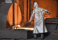 FILE - In this April 27, 2018 photo a worker controls iron at the Thyssenkrupp steel factory in Duisburg, Germany. The European Union and the United States have decided to temporarily suspend measures at the heart of a steel tariff dispute that is seen as one of the major trade issues dividing the two sides. The issue goes back to the 2018 tariffs that then-President Donald Trump slapped on EU steel and aluminum, which enraged Europeans and other allies by calling their metals a threat to U.S. national security. (AP Photo/Martin Meissner, File)