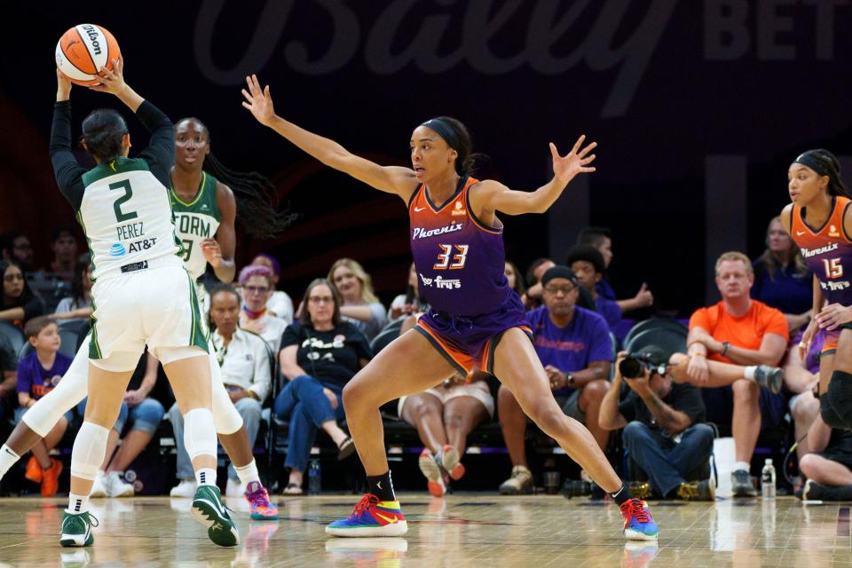 Raina Perez, 2, goes to pass to teammate Ezi Magbegor, 13, as she's guarded by Mercury's Kristine Anigwe, 33, at Phoenix Mercury's preseason opener against the Seattle Storm at the Footprint Center on April 28, 2022, in Phoenix, AZ.