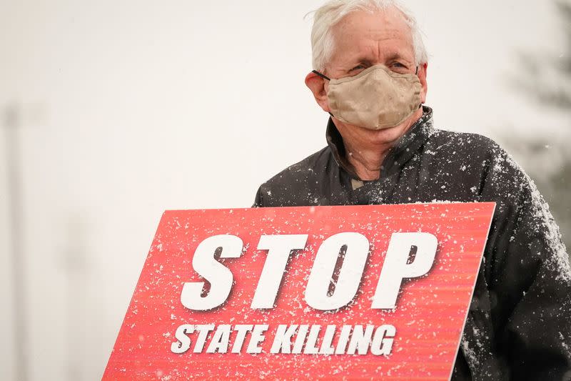 An activist in opposition to the death penalty protests outside of the United States Penitentiary in Terre Haute