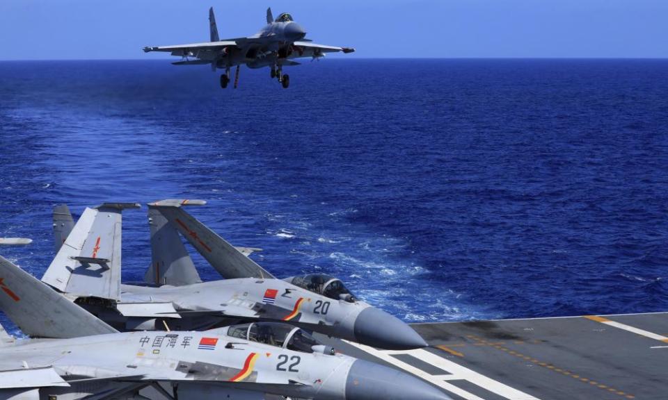 A J-15 fighter jet prepares to land on the Chinese navy’s Liaoning aircraft carrier during open-sea combat training in the politically sensitive South China Sea.