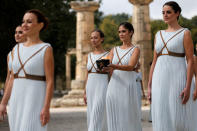 Olympics - Dress Rehearsal - Lighting Ceremony of the Olympic Flame Pyeongchang 2018 - Ancient Olympia, Olympia, Greece - October 23, 2017 Actresses with the flame during the dress rehearsal for the Olympic flame lighting ceremony for the Pyeongchang 2018 Winter Olympic Games at the site of ancient Olympia in Greece REUTERS/Alkis Konstantinidis