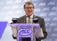 FILE - In this July 18, 2018, file photo, Atlantic Coast Conference commissioner John Swofford speaks during a news conference at the ACC NCAA college football media day in Charlotte, N.C. After the Power Five conference commissioners met Sunday, Aug. 9, 2020, to discuss mounting concern about whether a college football season can be played in a pandemic, players took to social media to urge leaders to let them play.(AP Photo/Chuck Burton, File)