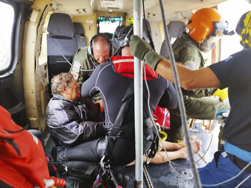 In this photo provided by the Ministry of Climate Crisis & Civil Protection, rescuers by helicopter save a woman from floodwaters in the village of Agia Triada, near Karditsa, Thessaly region, central Greece, Thursday, Sept. 7, 2023. Greece's fire department says more than 800 people have been rescued over the past two days from floodwaters, after severe rainstorms turned streets into raging torrents, hurling cars into the sea and washing away roads.(Ministry of Climate Crisis & Civil Protection via AP)