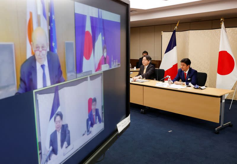 Japan's Foreign Minister Yoshimasa Hayashi and Defence Minister Nobuo Kishi attend a video conference with France's Foreign Minister Jean-Yves Le Drian and Defence Minister Florence Parly