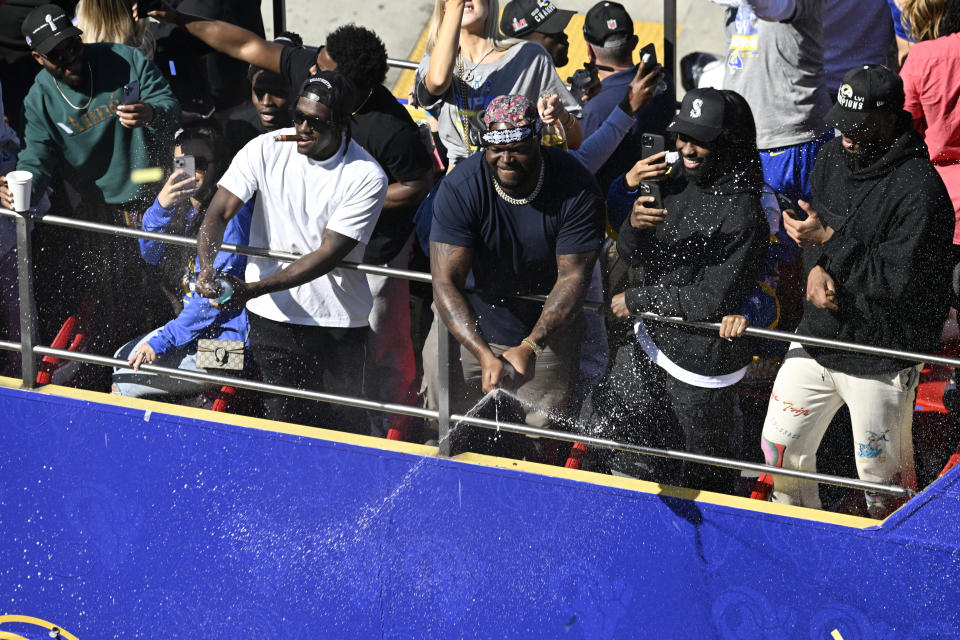 Los Angeles Rams players celebrate during the team's victory parade in Los Angeles, Wednesday, Feb. 16, 2022, following their win Sunday over the Cincinnati Bengals in the NFL Super Bowl 56 football game. (AP Photo/Kyusung Gong)