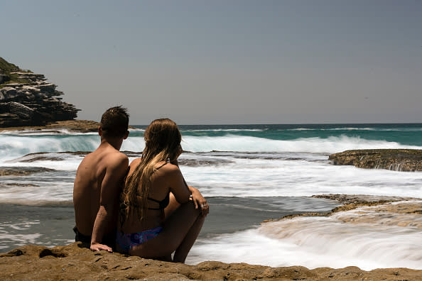 A couple enjoy the warm start to summer at Tamarama, Sydney.