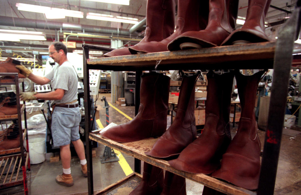 GENERAL INFORMATION: Red Wing, Mn., Tues., May 15, 2001--Tour of Red Wing Boot Co. manufacturing plant and of the S B Foot Tanning Co. ehich is owned by Red Wing and supplies its leather.

IN THIS PHOTO: Ken Frazier forms the toes  of boots with a heat press. That's some of his product on the rack.(Photo By DUANE BRALEY/Star Tribune via Getty Images)