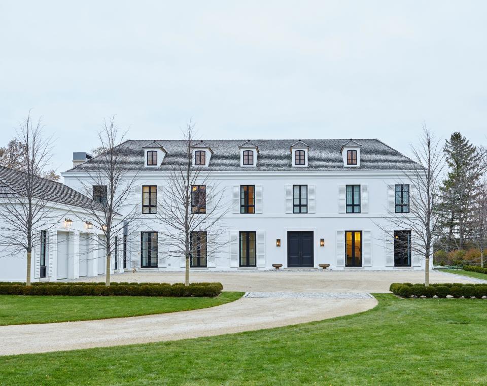 Mann worked with Northworks Architects over the span of three years to imbue a 16,000-square-foot Georgian-style residence on the shores of Lake Michigan with European-inspired elegance. Shutters were kept monochrome and windows feature steel mullions to add contemporary flair.