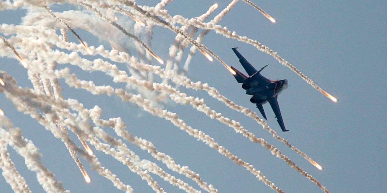'Russian Knights' air force group member flies over Monino airfield on his jet SU-27 during an aerial show to commemorate the 95th anniversary of Russian Air Forces outside Moscow, August 11, 2007