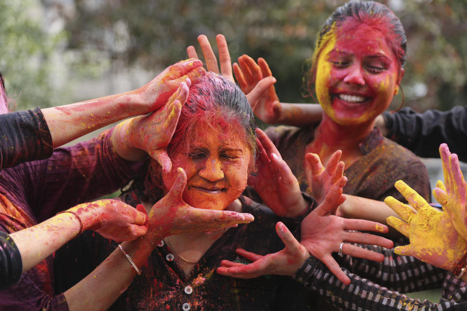 <p>Girls smear colored powder on each other as they celebrate Holi in Jammu, India, Thursday, March 1, 2018. (Photo: Channi Anand/AP) </p>