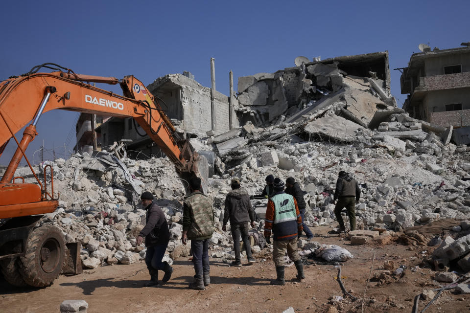 Rescue workers clear the rubble from collapsed houses in Atareb, Syria, Sunday, Feb. 12, 2023. Six days after a massive earthquake killed thousands in Syria and Turkey, sorrow and disbelief are turning to anger and tension over a sense that there has been an ineffective, unfair and disproportionate response to the historic disaster. (AP Photo/Hussein Malla)