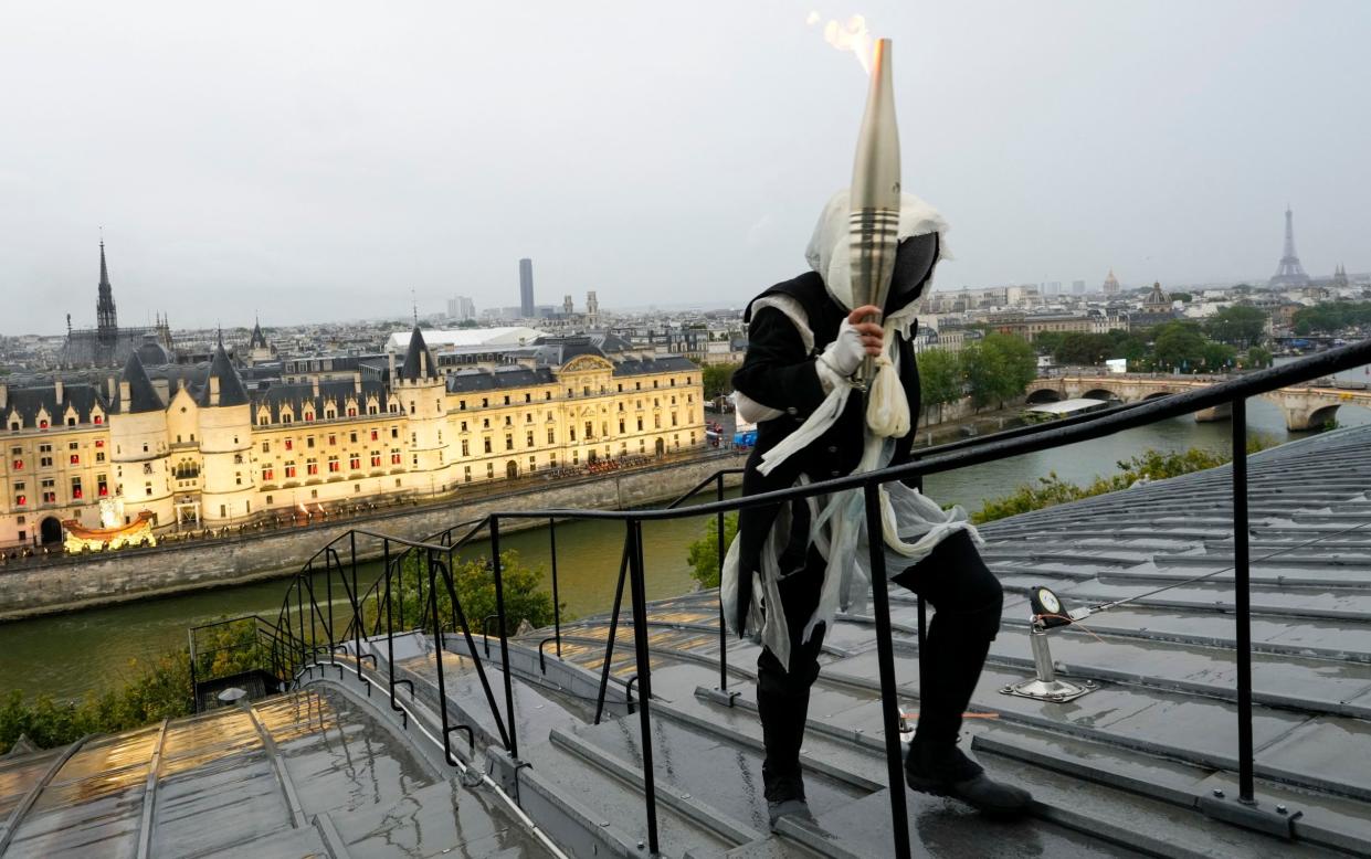 The mysterious masked person with the Olympic torch