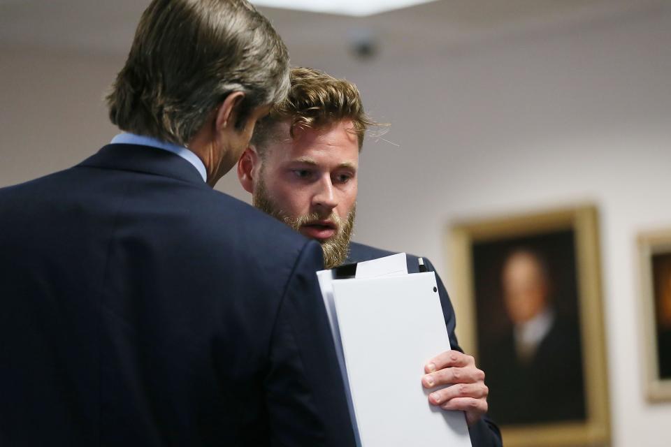 Andino Reynal, lawyer representing Alex Jones, speaks with Owen Shroyer, an InfoWars host and frequent guest on "The Alex Jones Show." He testified at the Travis County Courthouse on Friday in a defamation award trial centering on Alex Jones and his claims that the 2012 Sandy Hook school shooting was a hoax.