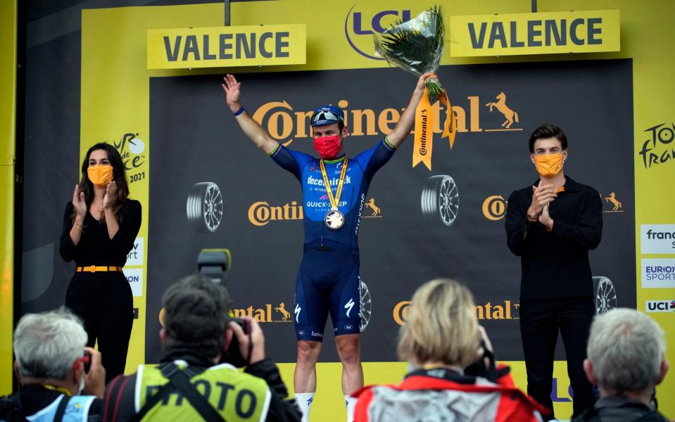 Britain's Mark Cavendish celebrates on the podium after winning the tenth stage of the Tour de France cycling race over 190.7 kilometers (118.5 miles) with start in Albertville and finish in Valence, France, Tuesday, July 6, 2021.  - AP