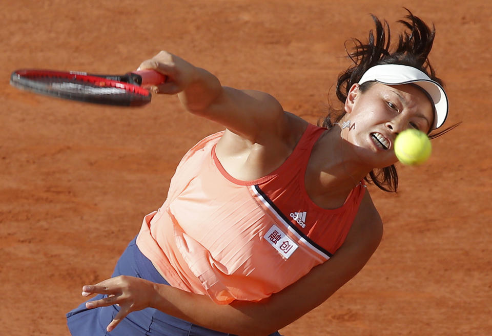 FILE - China's Shuai Peng serves the ball to France's Caroline Garcia during their second round match of the French Open tennis tournament at the Roland Garros stadium, Thursday, May 31, 2018, in Paris. Chinese authorities have squelched virtually all online discussion of sexual assault accusations apparently made by the Chinese professional tennis star against a former top government official, showing how sensitive the ruling Communist Party is to such charges. (AP Photo/Michel Euler, File)