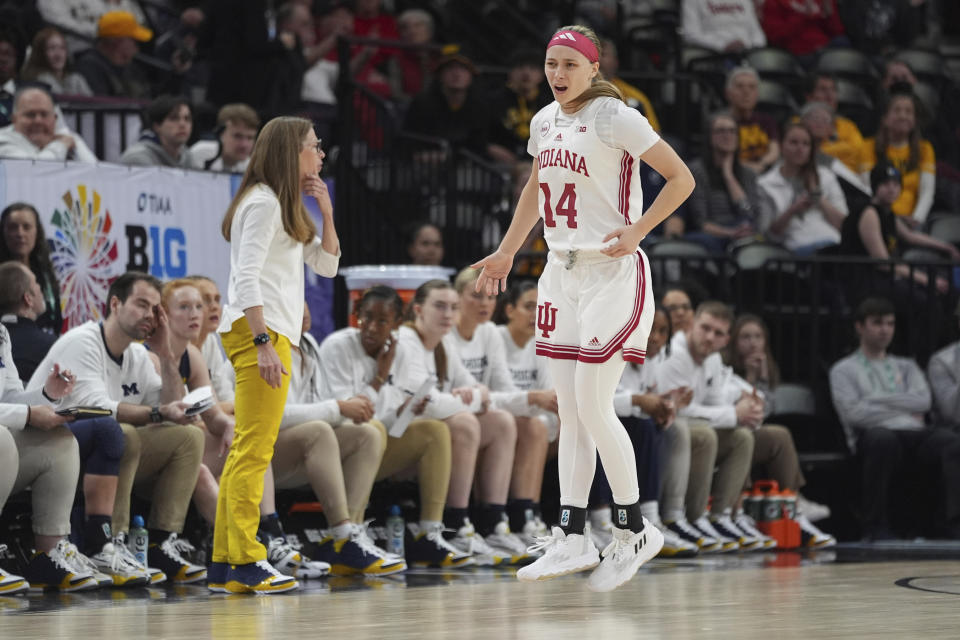 Indiana guard Sara Scalia (14) celebrates after making a 3-point basket against Michigan during the first half of an NCAA college basketball game against Michigan in the quarterfinals of the Big Ten women's tournament Friday, March 8, 2024, in Minneapolis. (AP Photo/Abbie Parr)