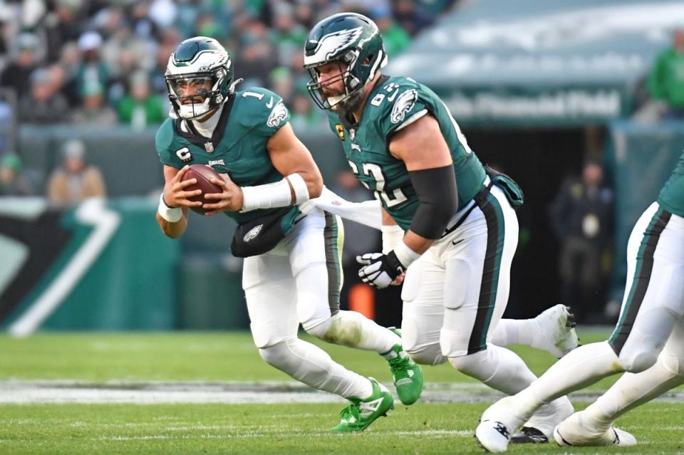 Dec 31, 2023; Philadelphia, Pennsylvania, USA; Philadelphia Eagles quarterback Jalen Hurts (1) runs with ball as center Jason Kelce (62) looks to block against the Arizona Cardinals at Lincoln Financial Field. Mandatory Credit: Eric Hartline-USA TODAY Sports