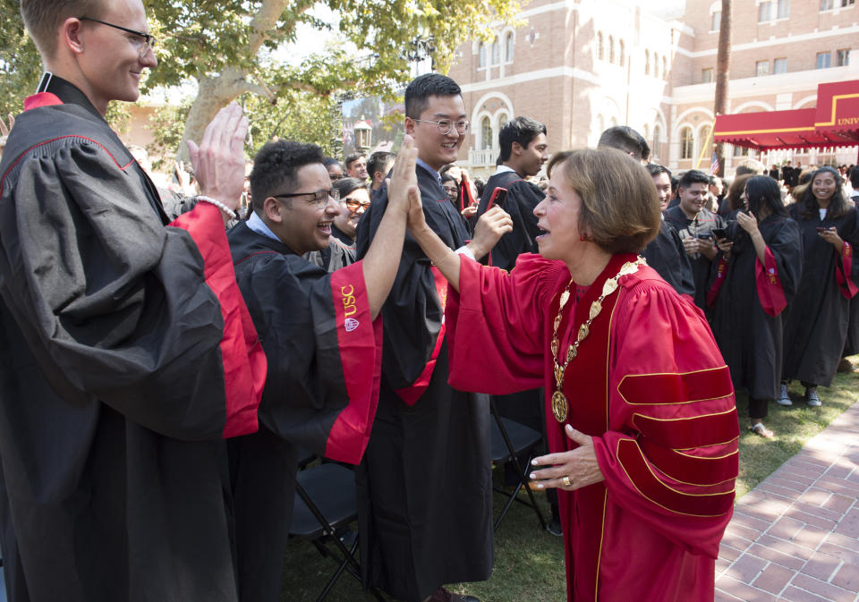 IMAGE DISTRIBUTED FOR USC - Carol L. Folt greets students following her inauguration ceremony as USC's 12th president Friday Sept. 20, 2019 in Los Angeles. (Phil McCarten/AP Images for USC)