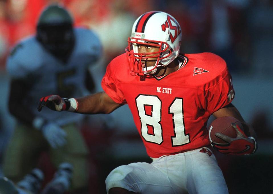 N.C. State wide receiver Torry Holt runs back a long punt return in a game against Georgia Tech in 1998, the year he became the ACC’s Player of the Year.