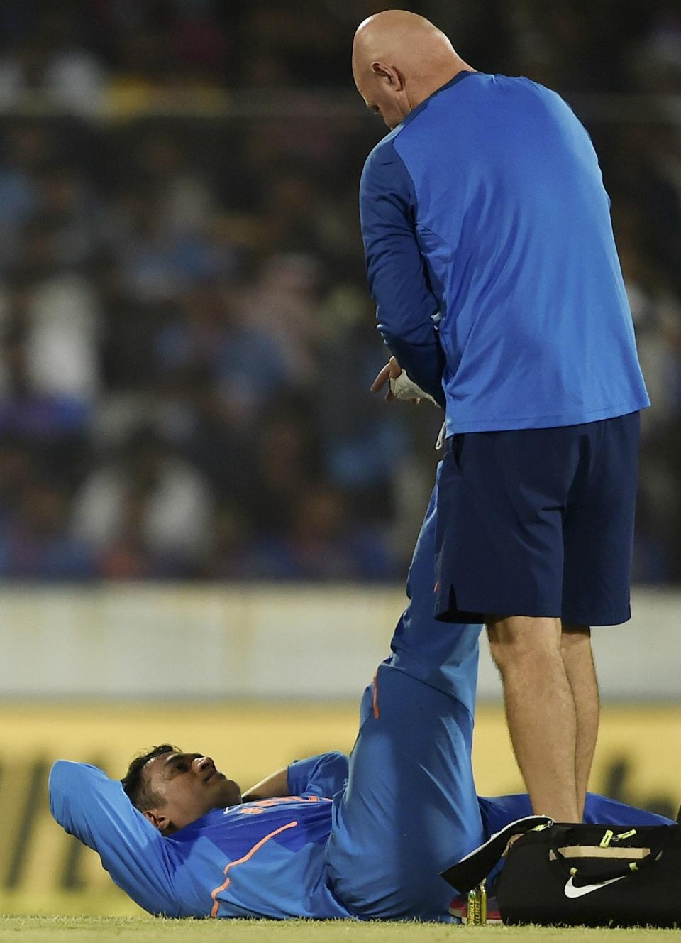 Hyderabad: Indian cricketer MS Dhoni gets medical assistance during the first One Day International (ODI) series cricket match against Australia, in Hyderabad, Saturday, March 2, 2019. (PTI Photo/R Senthil Kumar)(PTI3_2_2019_000216A)