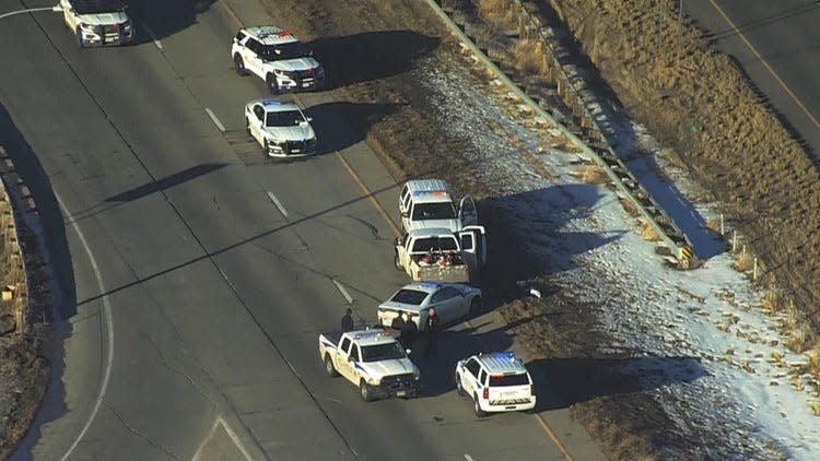 Law enforcement vehicles surround a suspect on Interstate 25 near Mulberry Street on Monday, Jan. 10, 2022. The Larimer County Sheriff's Office reported a deputy shot and injured a man after a chase that began in Wellington Monday afternoon.