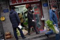 Residents buy food in a greengrocer's shop at a hutong, as the country is hit by an outbreak of the novel coronavirus, in Beijing