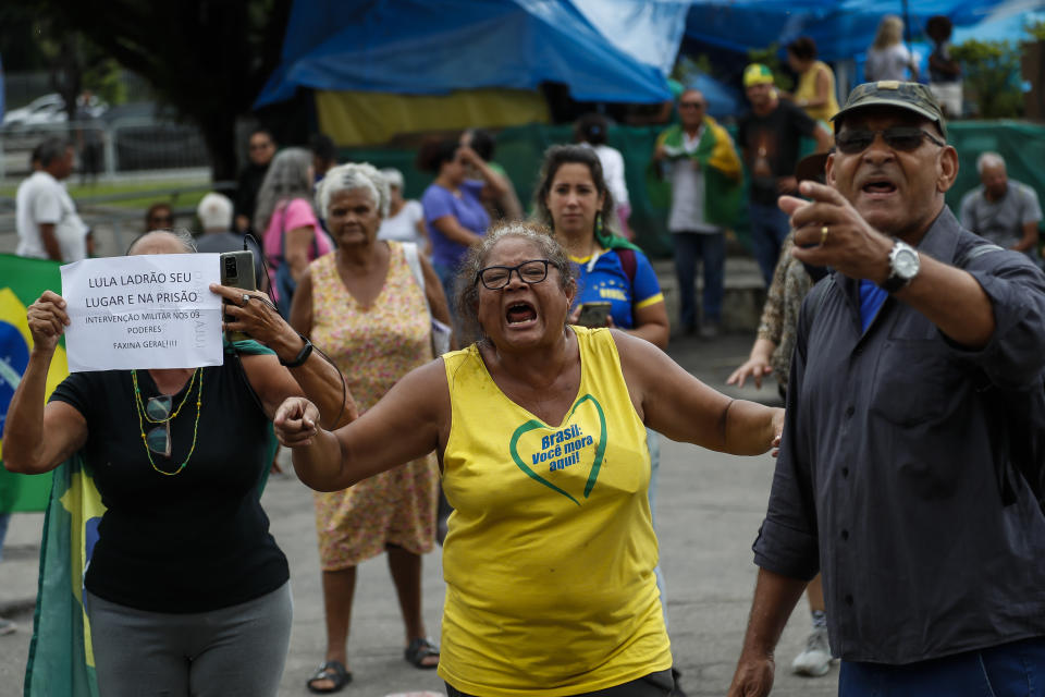 FILE - Supporters of outgoing President Jair Bolsonaro who refuse to accept the presidential election results, protest as they are forced to breakdown a pro-Bolsonaro encampment outside a military building, in Rio de Janiero, Brazil, Jan. 9, 2023. (AP Photo/Bruna Prado, File)