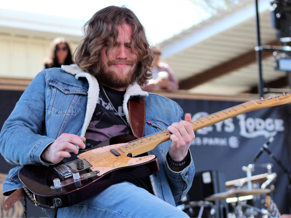 Jackson Hatch leans into a guitar solo during his set with Landon Talley to open the Saturday music program at the 2023 Outlaws & Legends Music Festival. April 1 2023