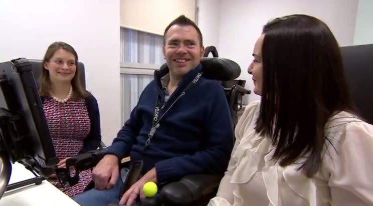 Jason Liversidge, with his wife, Liz, right, smiles as he hears his new voice for the first time (Picture: PA)