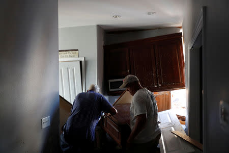 Charles Anderson, 76, (L) of Thomasville, GA, and Mark Drake, 55, of Tallahassee, enter Anderson's vacation home damaged by Hurricane Michael in Mexico Beach, Florida, U.S., October 16, 2018. REUTERS/Terray Sylvester