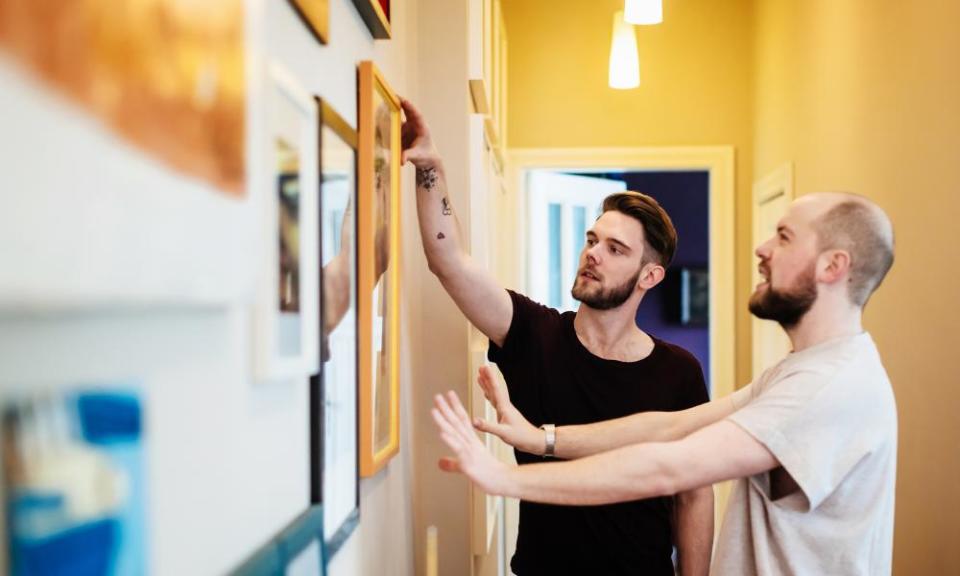 Couple hanging a picture together