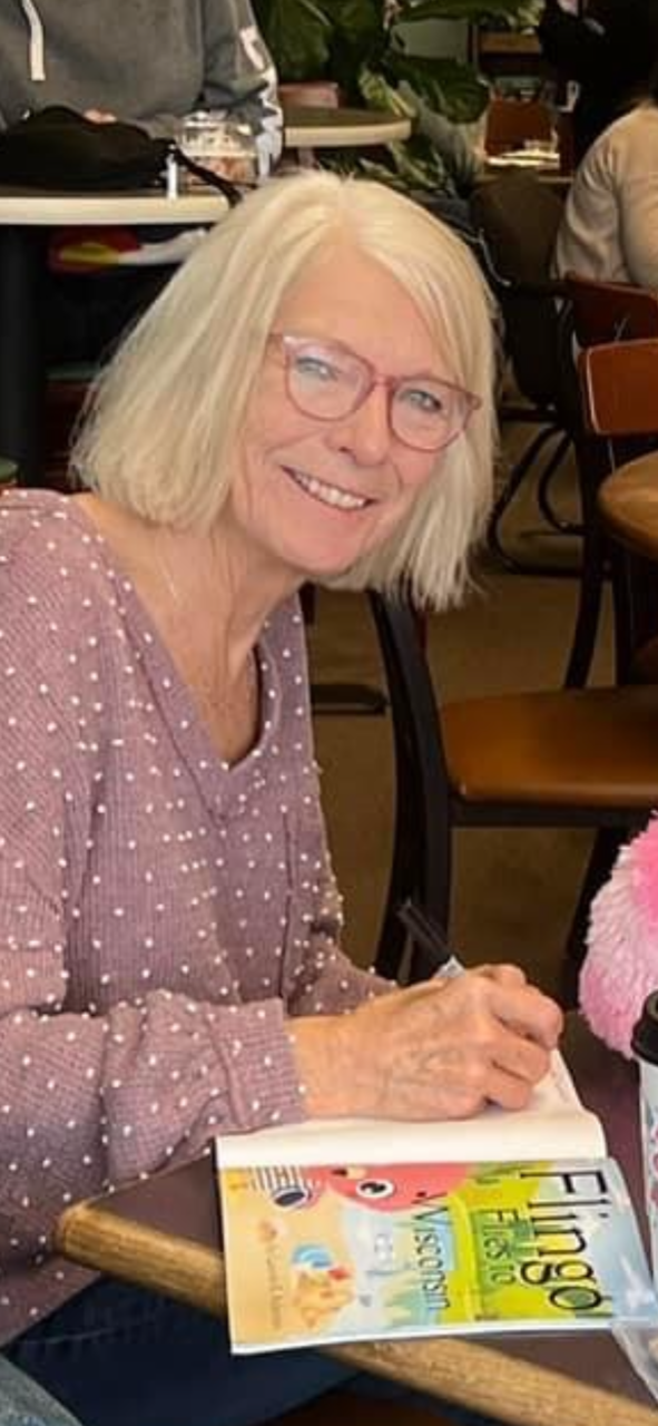 Oconomowoc author Lauren Ackerman, shown reading her book at Java Nut in Oconomowoc, wrote a children's book, "Flingo Flies to Wisconsin," based on the rare appearance of flamingos in Port Washington in September 2023.