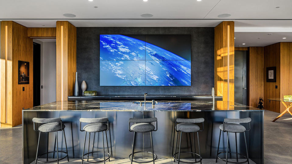 The entertainment bar with a TV wall of four 65-inch screens. - Credit: Beverly Hills Estates