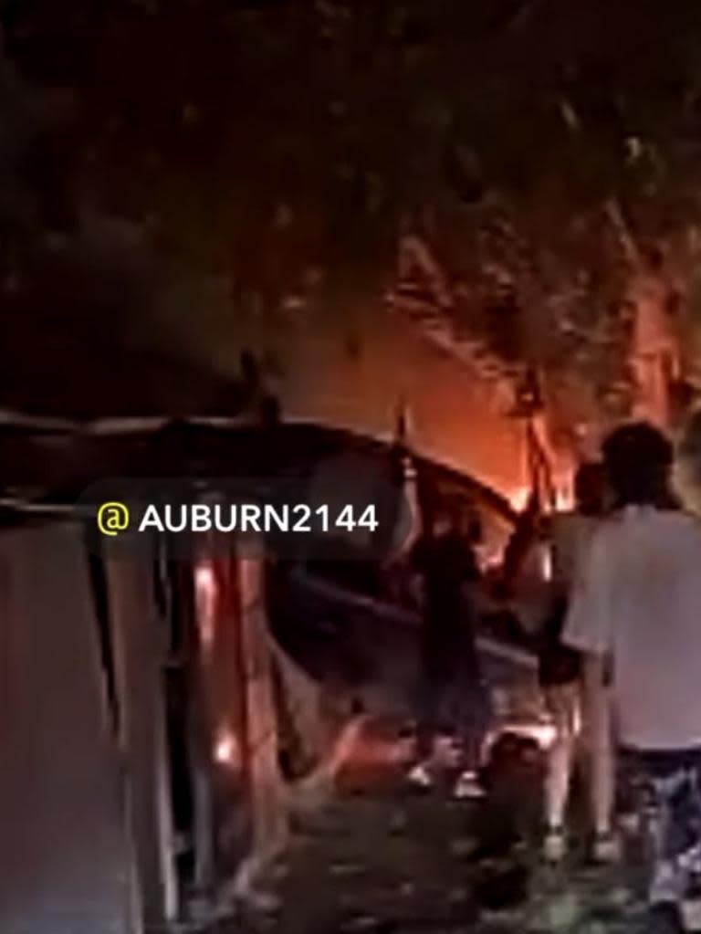 Their car hit a white Lexus before slamming into a fence, a tree and catching alight. Picture: Auburn2144