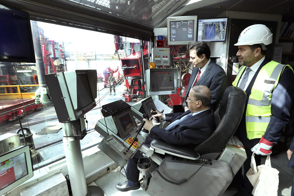 In this photo released by Lebanon's official government photographer Dalati Nohra, Lebanese President Michel Aoun, foreground, and Lebanese Prime Minister Hassan Diab, background, inspect the drilling ship Tungsten Explorer which will be conducting drilling operations of the first exploration well, located approximately 30 kilometers (18 miles) offshore from the capital Beirut Lebanon, Thursday, Feb. 27, 2020. Aoun inaugurated the Mediterranean country's first offshore exploratory drilling for oil and gas, calling it a "historic day" for the cash-strapped country. (Dalati Nohra via AP)