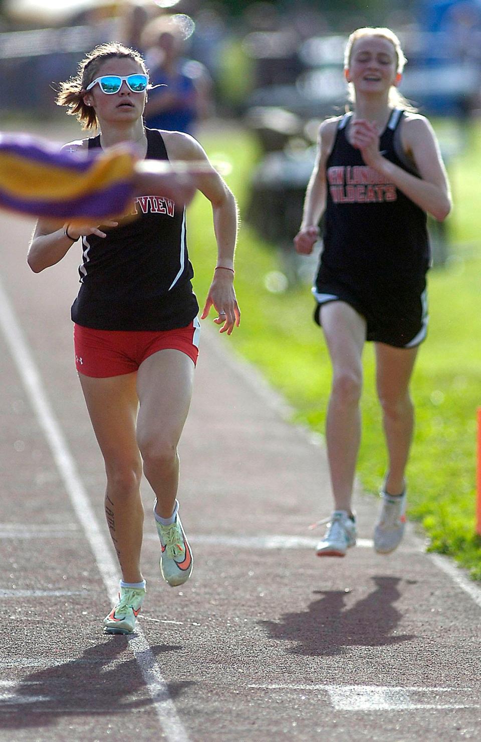 Crestview's Morgan Welch and New London's Reese Landis run in the 1,600 meters at  Firelands Conference Championships at New London Friday, May 13, 2022.