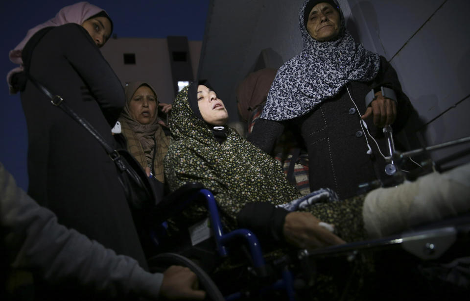 Relatives mourn in front of the morgue of Shifa hospital while wait to see the body of a woman who was shot and killed by Israeli troops during a protest at the Gaza Strip's border with Israel, in Gaza City, Friday, Jan. 11, 2019. Spokesman Ashraf al-Kidra says the woman was shot in the head Friday at a protest site east of Gaza City. (AP Photo/Adel Hana)
