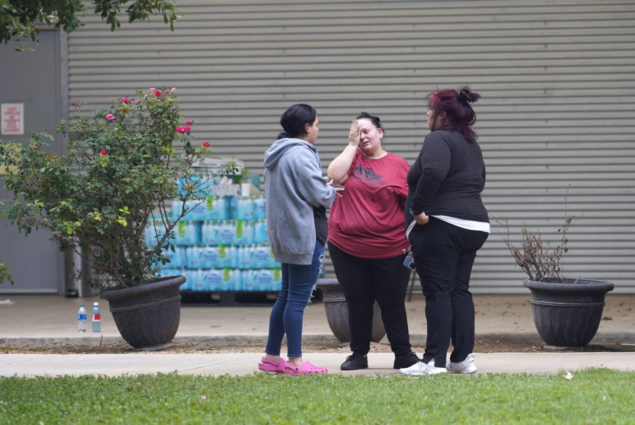 <span class="caption">Friends and families gather outside the civic center after the mass school shooting on May 24, 2022, in Uvalde, Texas. </span> <span class="attribution"><a class="link " href="https://www.gettyimages.com/detail/news-photo/friends-and-families-gather-in-mourning-outside-the-willie-news-photo/1240884434?adppopup=true" rel="nofollow noopener" target="_blank" data-ylk="slk:Allison Dinner/AFP via Getty Images;elm:context_link;itc:0;sec:content-canvas">Allison Dinner/AFP via Getty Images</a></span>