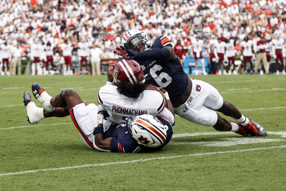 Massachusetts quarterback Taisun Phommachanh (3) is stopped at the goal line by Auburn cornerback Keionte Scott, bottom, and linebacker Austin Keys (6) during the first half of an NCAA college football game Saturday, Sept. 2, 2023, in Auburn, Ala. (AP Photo/Butch Dill)