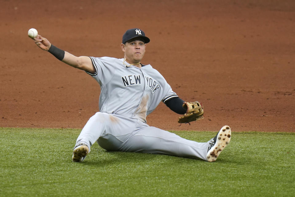 New York Yankees third baseman Gio Urshela throws out Tampa Bay Rays' Brandon Lowe at first after a diving stop during the fifth inning of a baseball game Saturday, April 10, 2021, in St. Petersburg, Fla. (AP Photo/Chris O'Meara)